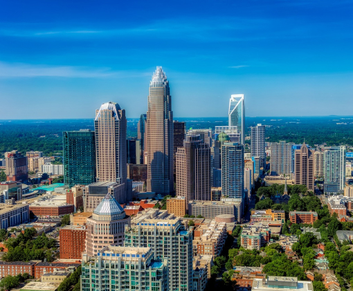 Uptown Charlotte NC real estate featuring modern skyline and condos for sale with Yubeen Choi Realtor.
