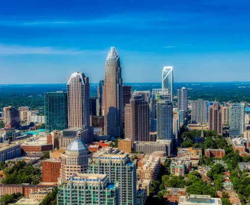 Uptown Charlotte NC real estate featuring modern skyline and condos for sale with Yubeen Choi Realtor.
